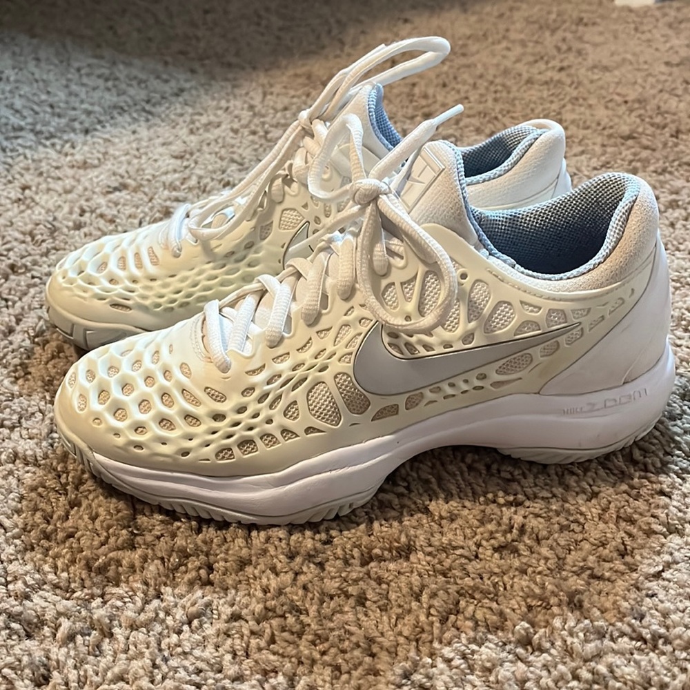 Nike tennis shoes, size 7.5 women’s, color is white, cream, silver, and blue.